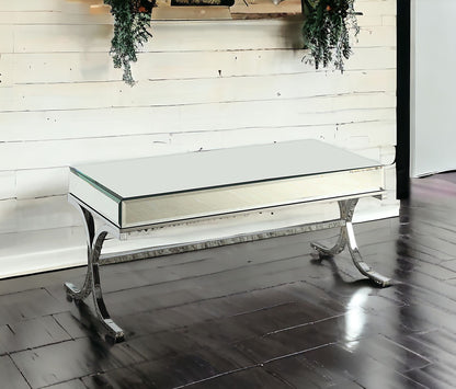 42" Clear and Silver Mirrored Glass And Iron Sled Coffee Table
