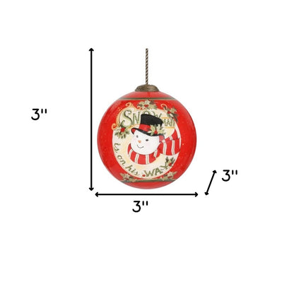 Festive Snowman on His Way Hand Painted And Mouth Blown Red And White Glass Ball Ornament