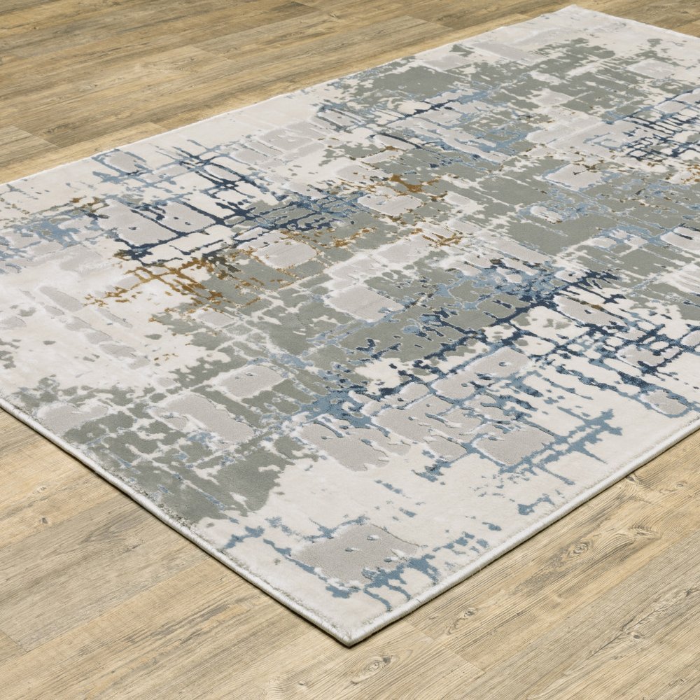5' X 8' Grey Blue Brown Ivory And Deep Blue Abstract Power Loom Stain Resistant Area Rug