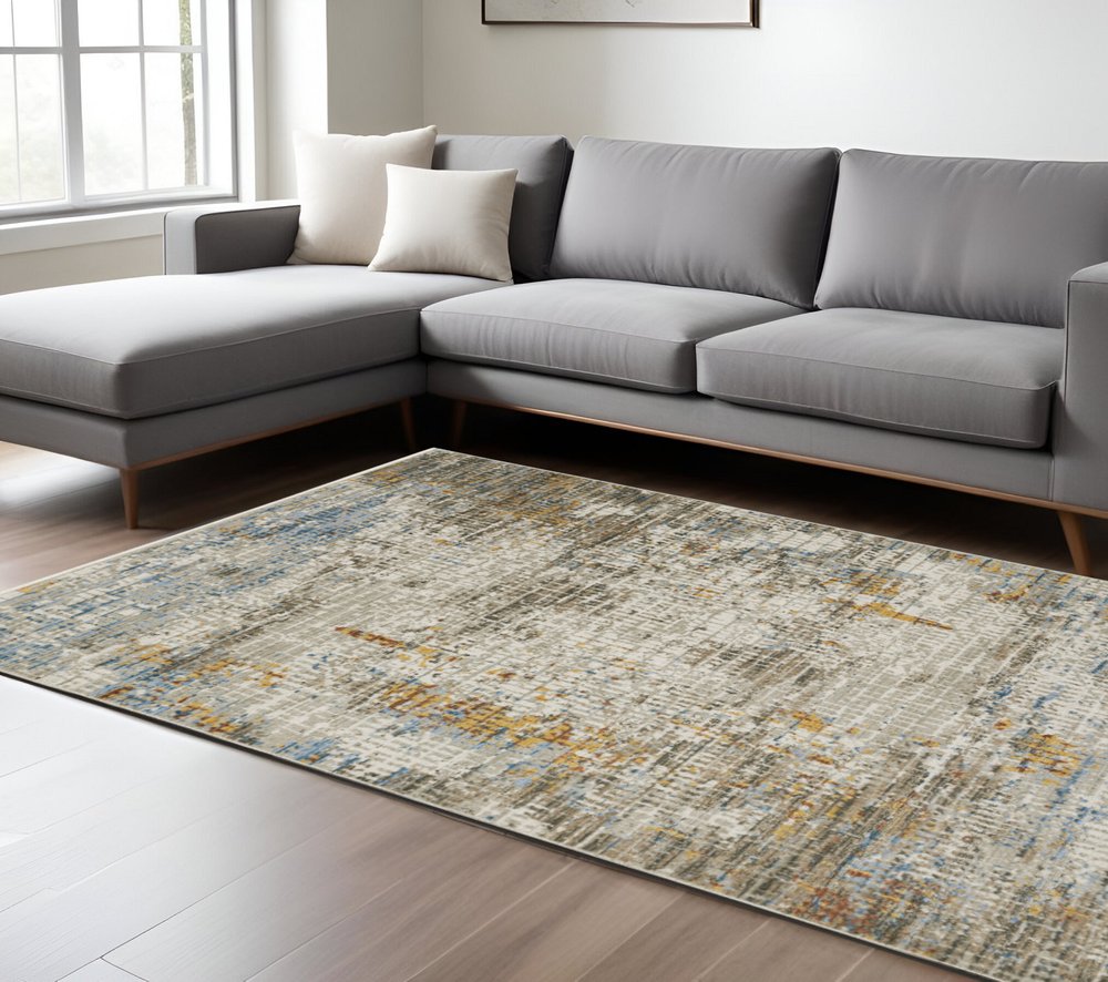 4' X 6' Beige Grey Brown Gold Red And Blue Abstract Power Loom Stain Resistant Area Rug With Fringe