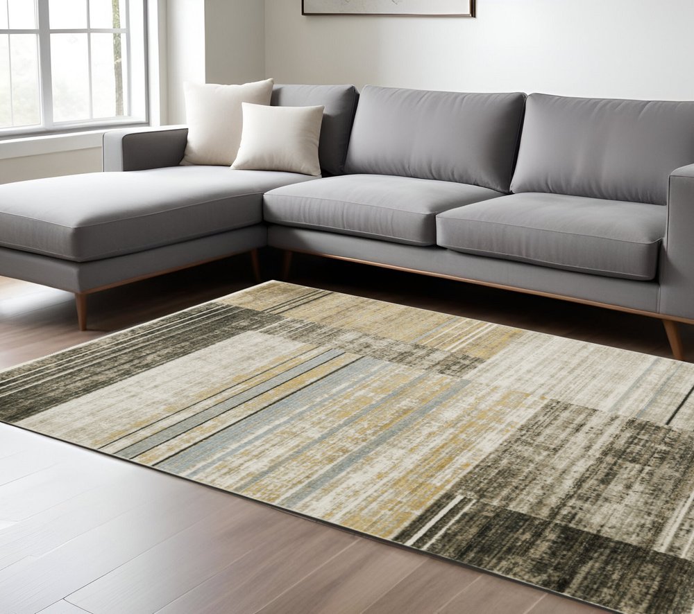 5' X 8' Beige Charcoal Brown Grey Tan Gold And Blue Geometric Power Loom Stain Resistant Area Rug With Fringe