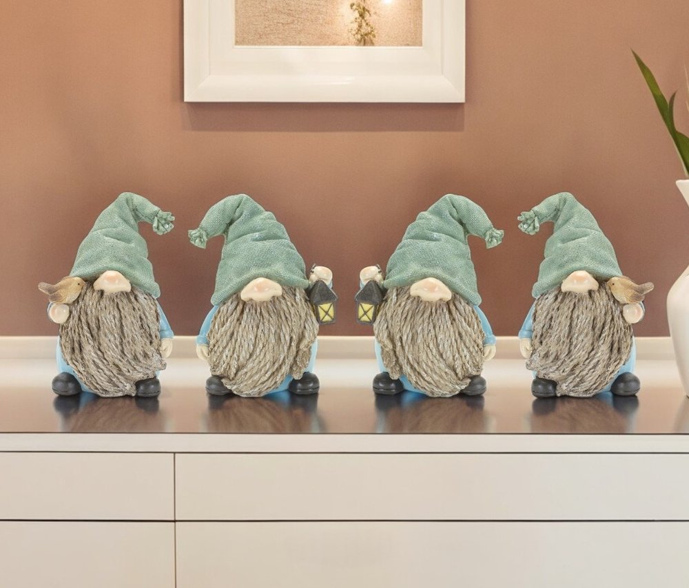 Set of Four Blue and Green Polyresin Christmas Figurine Tabletop Sculpture