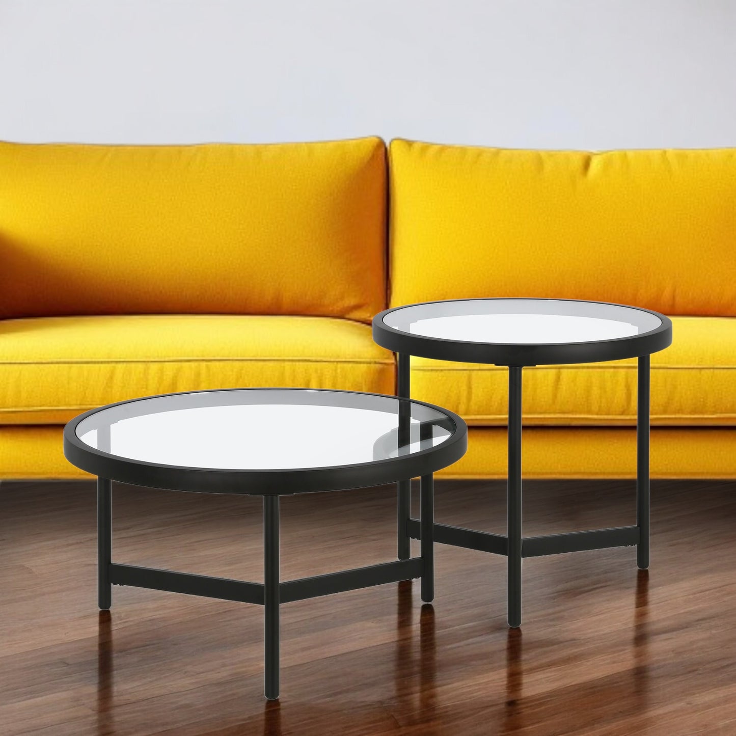 Set of Two 30" Black Glass And Steel Round Nested Coffee Tables