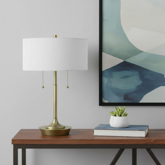 20" Antiqued Brass Metal Two Light Table Lamp With White Drum Shade