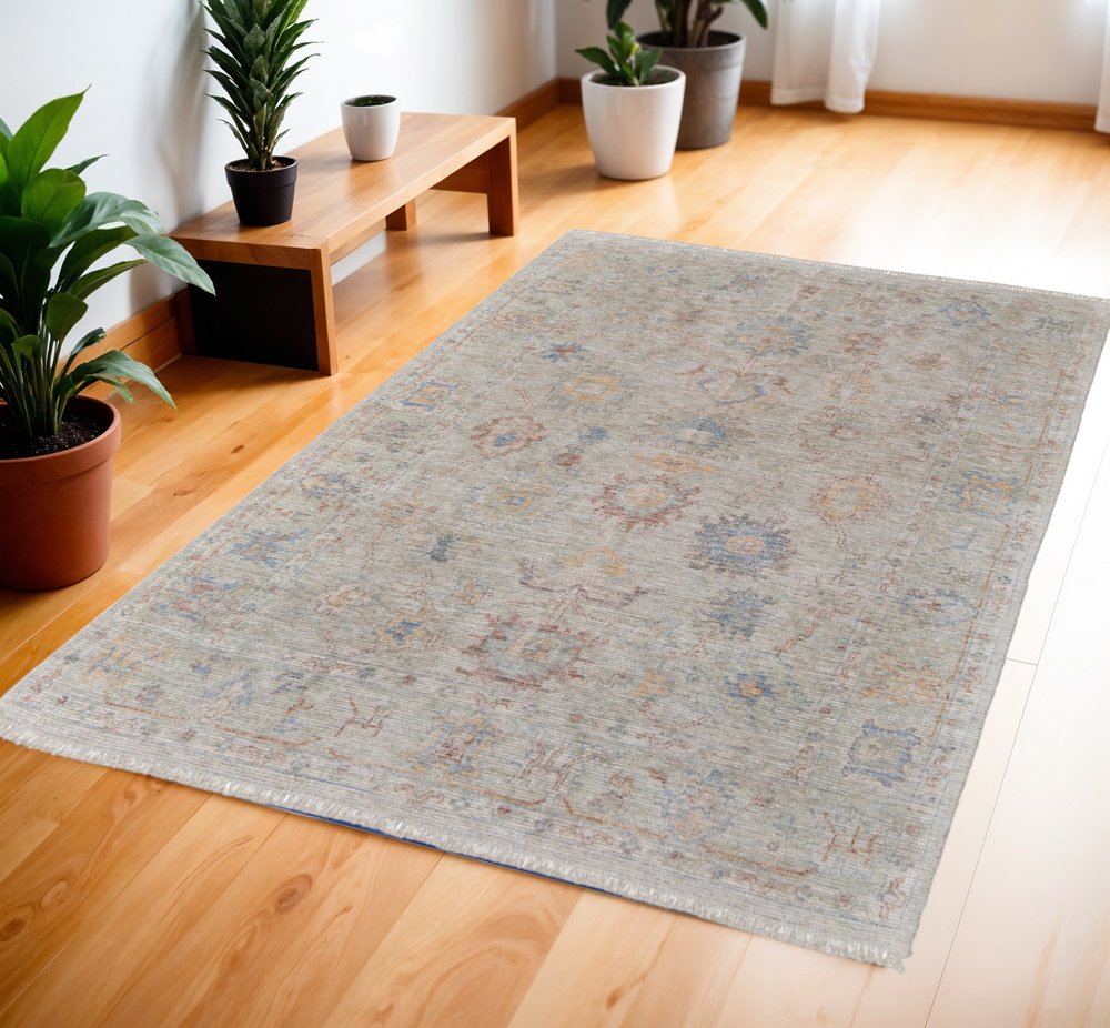 9' X 12' Tan Brown and Blue Floral Hand Woven Distressed Area Rug With Fringe