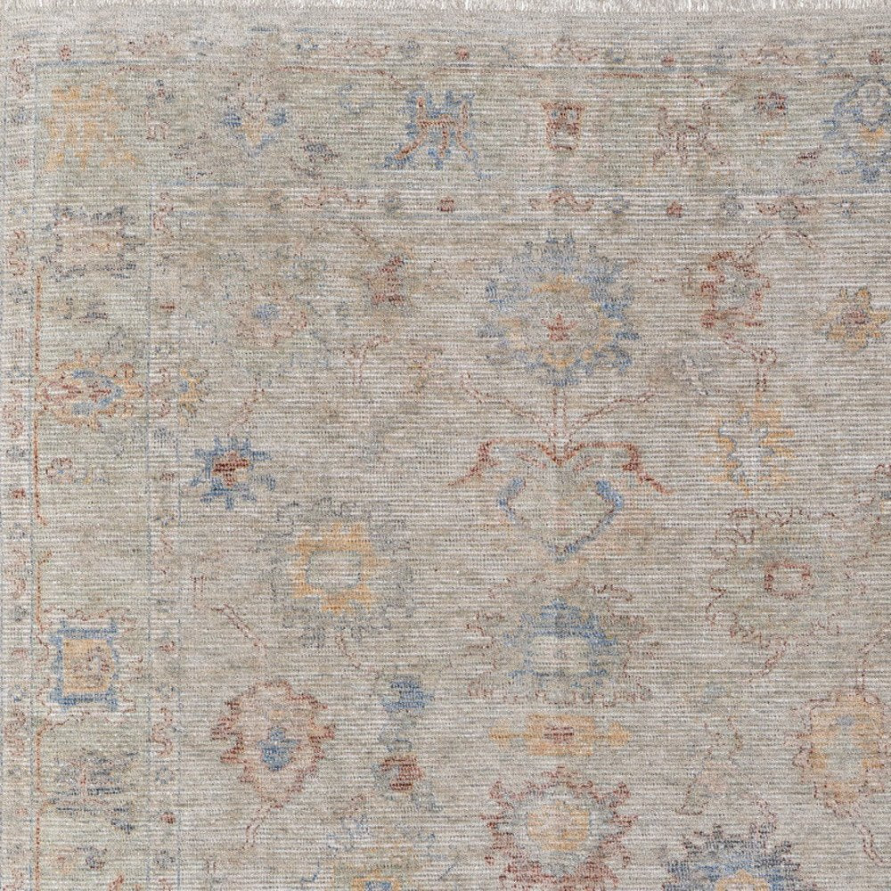 9' X 12' Tan Brown and Blue Floral Hand Woven Distressed Area Rug With Fringe
