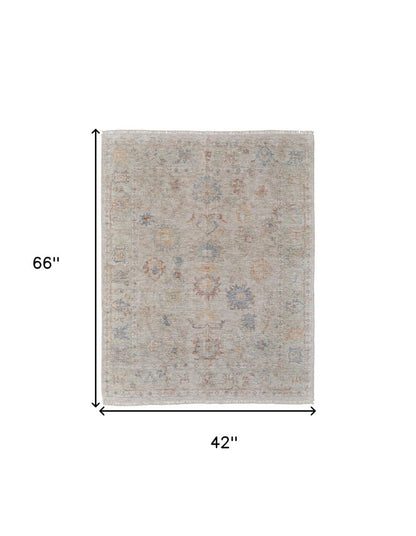 4' X 6' Tan Brown and Blue Floral Hand Woven Distressed Area Rug With Fringe