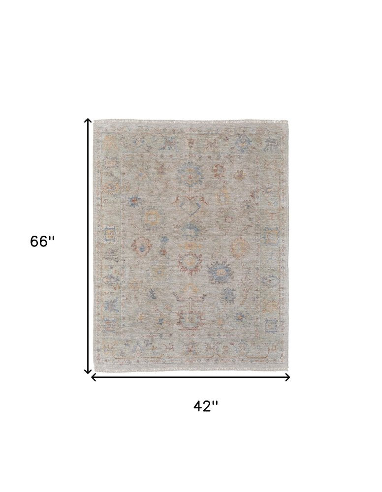 9' X 12' Tan Brown and Blue Floral Hand Woven Distressed Area Rug With Fringe