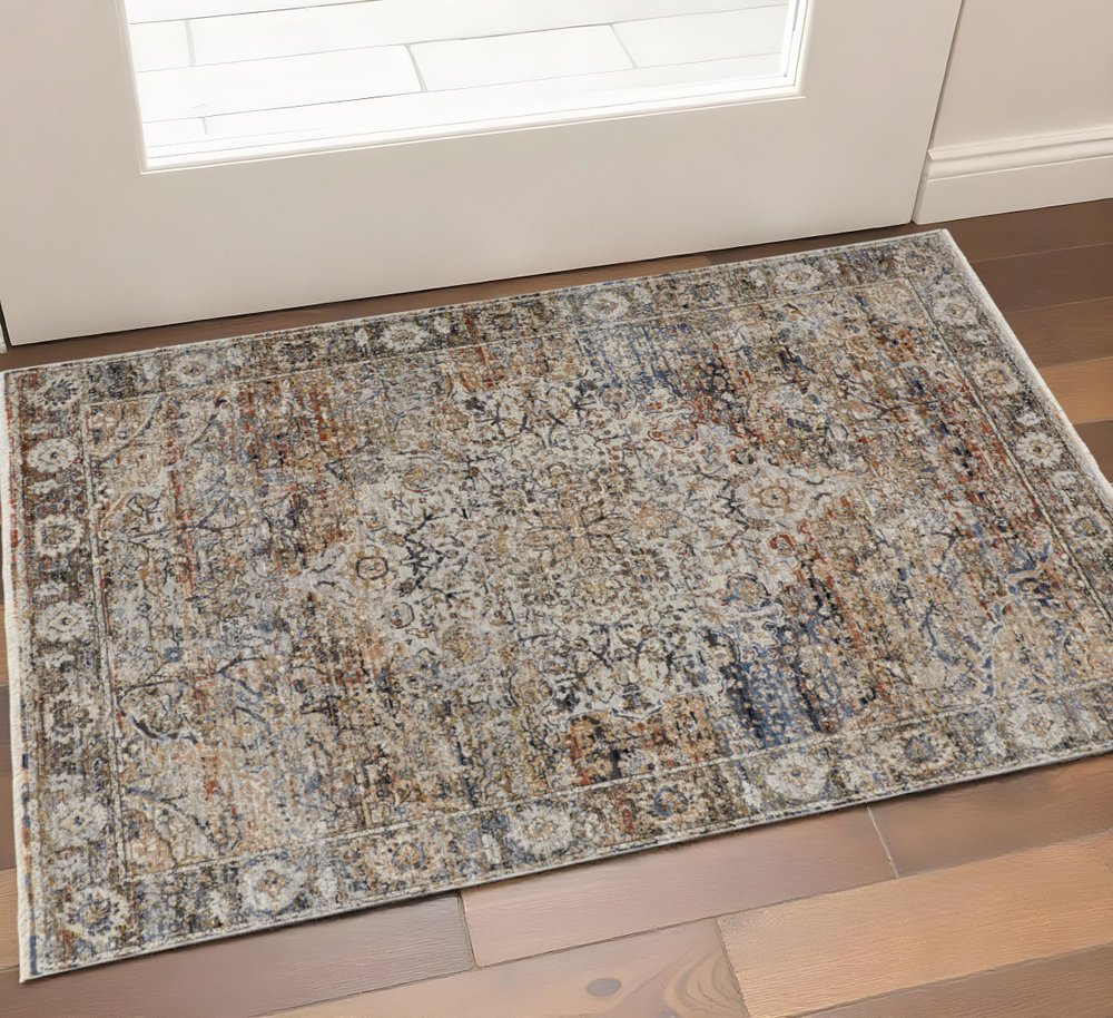 3' X 5' Tan Blue And Burnt Orange Oriental Area Rug With Fringe